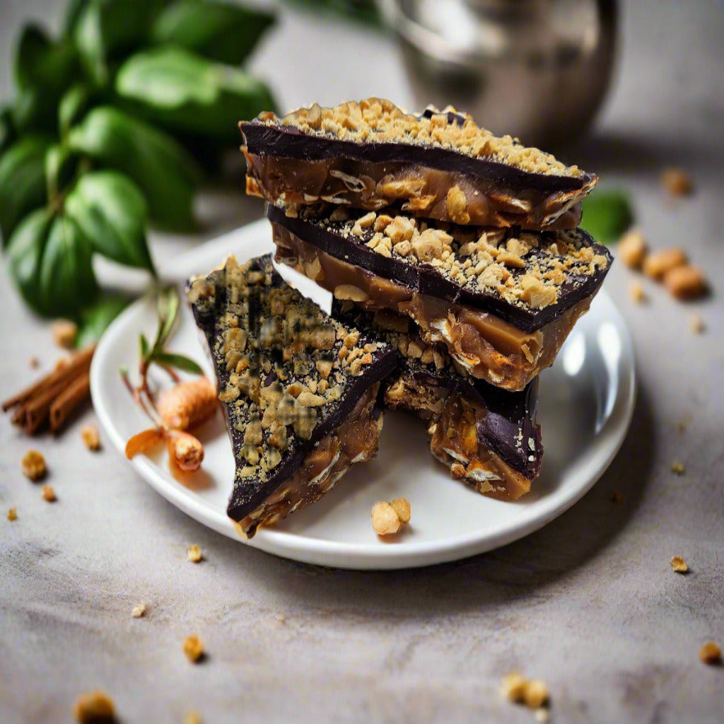 Mouthwatering toffee layered over whole pretzels, peanut butter drizzled with peanut butter and topped with a generous layer of chocolate and sprinkled with chopped peanuts